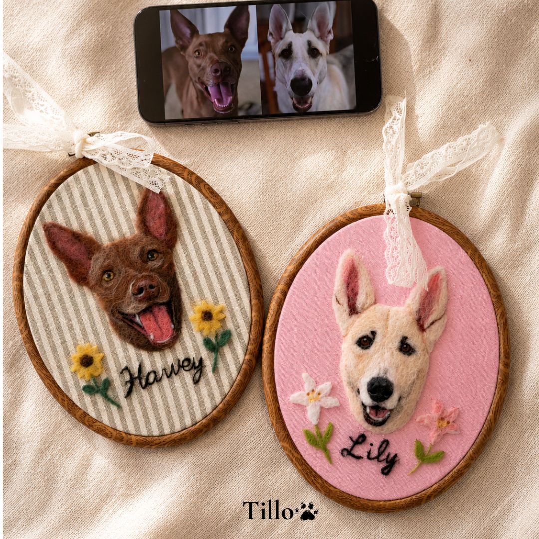 Two embroidered dog portraits with names 'Harvey' and 'Lily' on a beige fabric background, with a phone showing a similar image above.